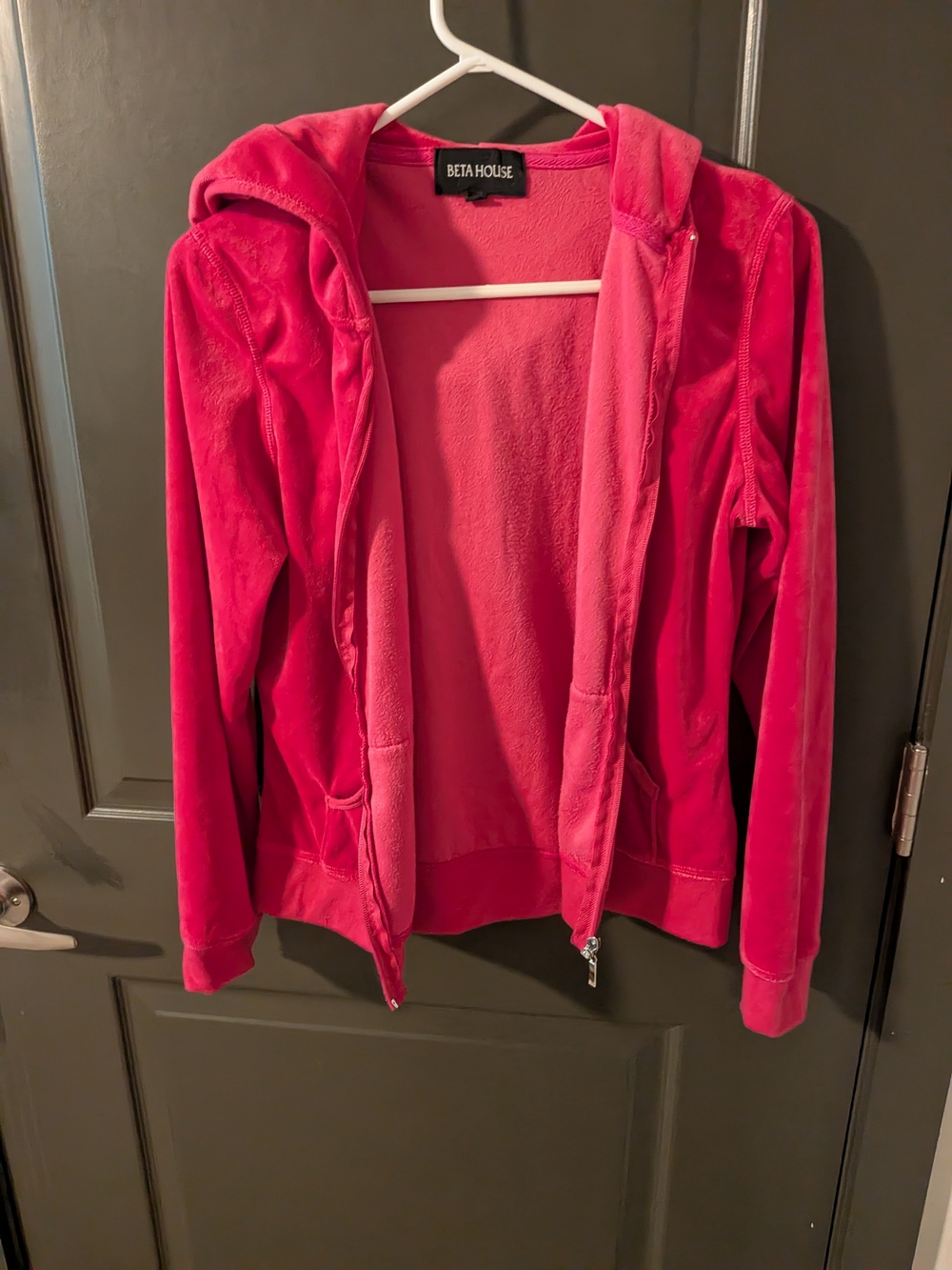 Beta House pink velour zip-up hoodie features a plush fabric and front pockets.